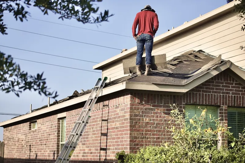 Professional roofer working on a residential roof in Cahokia Heights